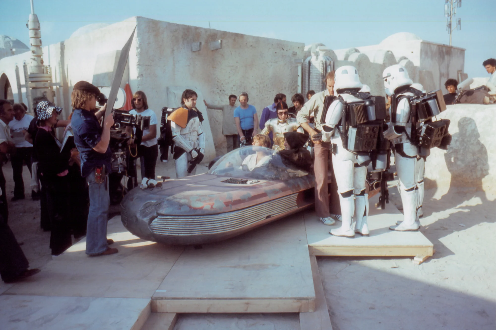 Wide behind the scenes view of the Star Wars landspeeder set and unmasked Sandtrooper Anthony Forrest